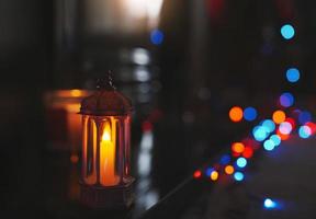 Arabic Lantern on black marble with blurry bokeh light background.Eid decorative traditional lamps illuminated ready for the Holy season of Ramadan Kareem.Concept for Islamic muslim holidays celebrate photo