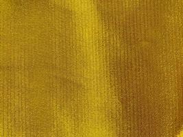 golden cloth fabric texture used as background. Empty golden cloth fabric background of soft and smooth textile material. There is space for text photo