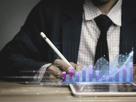 businessman working with business Analytics and Data Management System on tablet, online document management and metrics connected to database. Corporate strategy for finance, operations, sales. photo