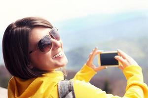 Tourist taking pictures in the mountains photo