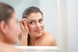 Young nice brunette woman in the bathroom photo