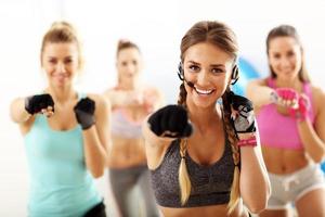 Group of smiling people doing aerobics photo