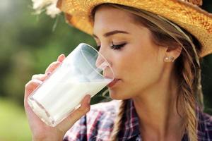 Young woman with fresh organic milk photo