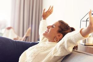 Adult woman wearing warm sweater resting at home one autumn day photo