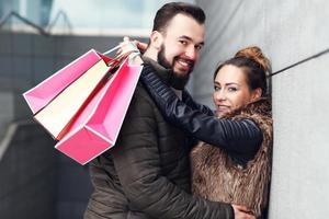 Happy couple shopping and hugging photo