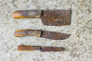 Rusty meat knife isolated on stone backgroundRusty meat knife isolated on stone background photo