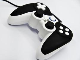 The gamepad is black and white on a white background. Game joystick close-up. A gamepad for a game console. photo