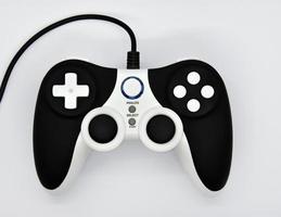 The gamepad is black and white on a white background. Game joystick close-up. A gamepad for a game console. photo