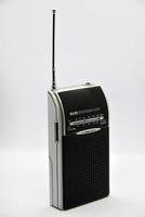 Portable radio receiver on a white background. Small player close-up. A battery-powered radio. photo