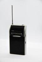 Portable radio receiver on a white background. Small player close-up. A battery-powered radio. photo