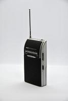 Portable radio receiver on a white background. Small player close-up. A battery-powered radio. photo