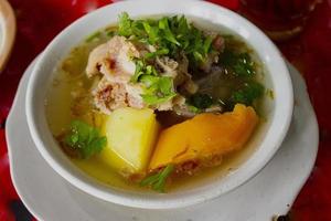 sop buntut or oxtail soup or tail soup is traditional soup made from tail ox, Boiled with Spices photo