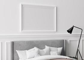 Blank horizontal picture frame on white wall in bedroom. Mock up poster frame in modern interior. Free space, copy space for your design. Bed, sideboard, lamp. 3D render, 3D illustration.