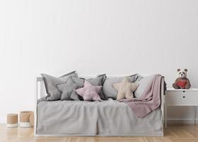 Empty white wall in modern child room. Mock up interior in scandinavian style. Free, copy space for your picture, poster. Bed, rattan baskets, toy. Cozy room for kids. 3D rendering.