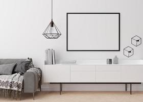 Empty black picture frame on white wall in modern living room. Mock up interior in contemporary style. Free space, copy space for your picture, poster. Sofa, sideboard, lamp, books. 3D rendering. photo