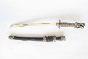 Japanese samurai short sword wakizashi , with dragon ornament, isolated on white background photo