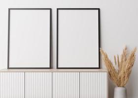 Two empty vertical picture frames standing on wooden sideboard. Mock up interior in contemporary style. Free space for picture, poster. Console, vase with pampas grass. 3D rendering. photo