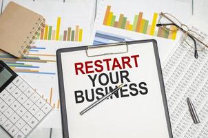 restart your business . Conceptual background with chart ,papers and pen photo