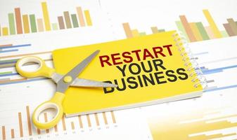 restart your business. Text on yellow notebook and charts photo