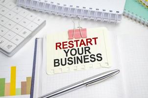 restart your business . Conceptual background with chart ,papers and pen photo