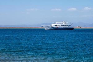 panoramic view of Red Sea with rows of rich yachts with mountains in background photo