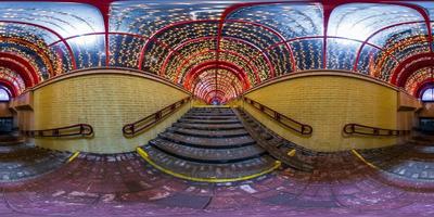 spherical night 360 panorama in festively lit underground passage tunnel with red frame arch and transparent dome and concrete staircase in equirectangular seamless projection, for VR AR content photo