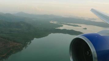 Aerial view of the sea coast in Thailand. Airliner is approaching to land on the island of Phuket. POV from the airplane window video