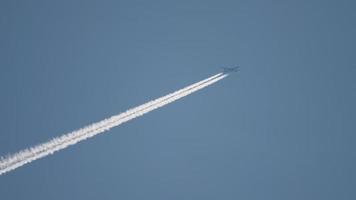 Airplane flying at high altitude with contrail video