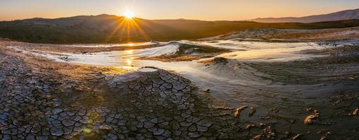 wide panoramic view of Mud volcanoes with stunning sunrise in Chahuna managed reserve in Georgia.