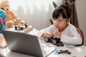 Asia students learn at home in coding robot cars and electronic board cables in STEM, STEAM, mathematics engineering science technology computer code in robotics for kids concept. photo