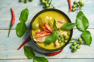 Green curry chicken cuisine asian food on the table - Thai food green curry on soup bowl with ingredient herb vegetable background photo