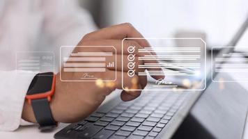 Paperless workplace ideas, e-signing, electronic signature, document management. A businessman signs an electronic document on a digital document on a virtual screen using a stylus pen. photo