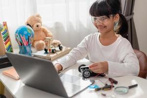 Asia students learn at home in coding robot cars and electronic board cables in STEM, STEAM, mathematics engineering science technology computer code in robotics for kids concept. photo