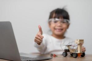 Asia students learn at home in coding robot cars and electronic board cables in STEM, STEAM, mathematics engineering science technology computer code in robotics for kids concept. photo