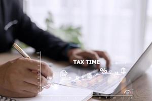 Concept of tax payment optimization business finance, people with taxes icon on technology screen, income tax and property, background for business, individuals and corporations such as VAT photo