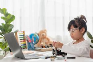 Asia students learn at home in coding robot cars and electronic board cables in STEM, STEAM, mathematics engineering science technology computer code in robotics for kids concept. photo