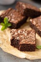 Freshly baked brownies on a parchment paper photo