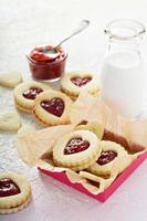 Heart shaped vanilla cookies with jam filling photo