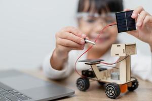 Asia students learn at home in coding robot cars and electronic board cables in STEM, STEAM, mathematics engineering science technology computer code in robotics for kids concept. photo
