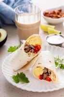 Breakfast burrito with sausage, eggs, bell pepper and cheese photo