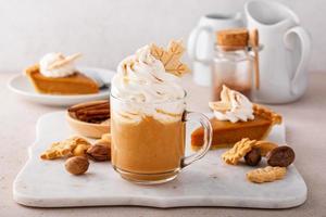 Pumpkin spice latte topped with whipped cream and cinnamon photo