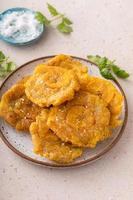 Tostones, traditional Carribean dish, twice fried plantains photo