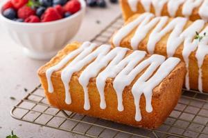 Classic pound cake with powdered sugar glaze dripping over photo