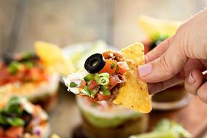 Seven layer dip in individual cups, mexican appetizer photo
