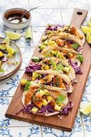Fish tacos with mango salsa and red cabbage photo