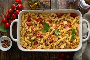 Baked feta pasta with cherry tomatoes and herbs photo