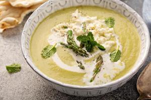 Asparagus and peas cream soup with mint photo