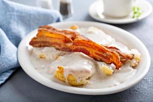 Biscuits and gravy with bacon for breakfast photo