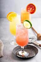 Refreshing cocktails or mocktails with oranges and cranberries photo