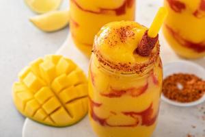 Mangonada mexican mango smoothie with chamoy sauce and lime seasoning photo